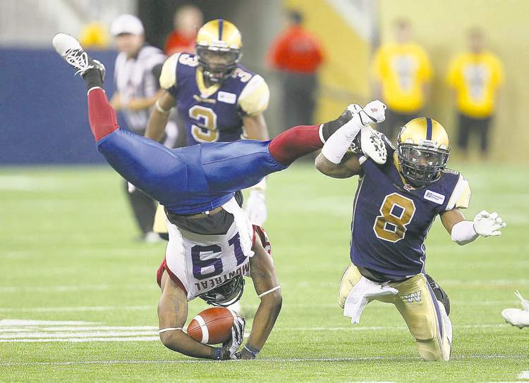 JOE BRYKSA / WINNIPEG FREE PRESS
Bombers linebacker Brandon Stewart puts Alouettes slotback S.J. Green on the turf during third quarter action Thursday night.