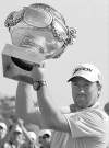 CP
michel euler / the associated pressGraeme McDowell needs all his strength to hoist French Open trophy.
