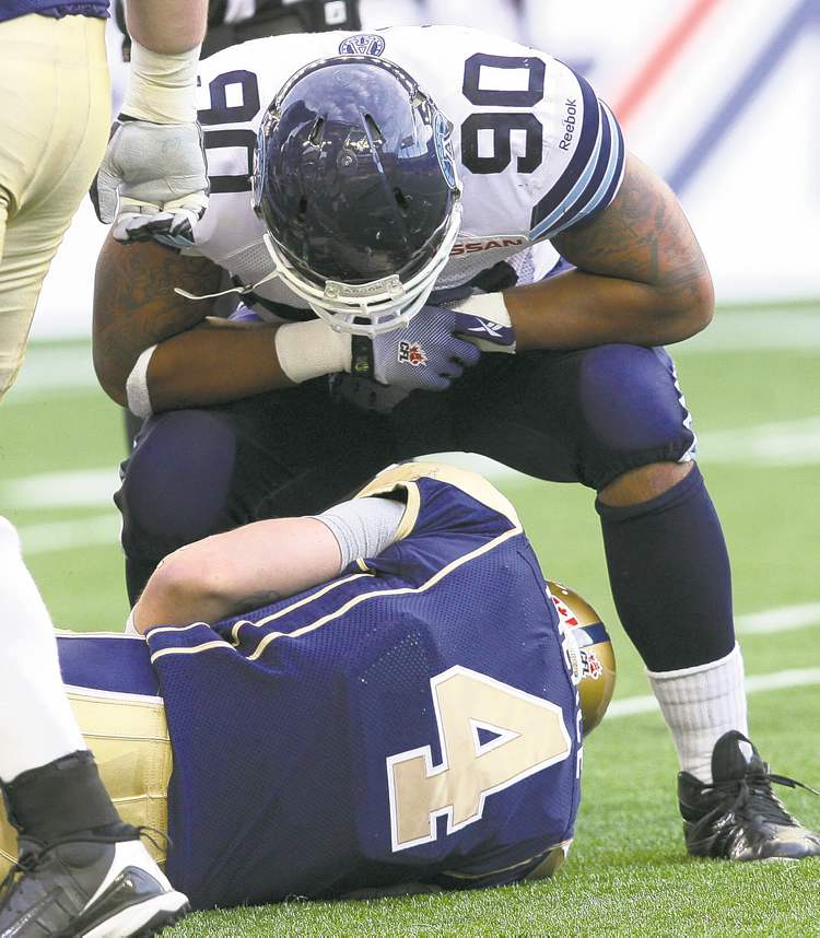 JOE BRYKSA / WINNIPEG FREE PRESS archives
Toronto Argonaut Cleyon Lang adds insult to injury after pulverizing Buck Pierce Friday night.