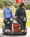 CP
Scott Heppell / the associated pressMichelle Wie (left) is driven back to the clubhouse after the wind stopped play during the third round of the Women�s British Open tournament.