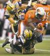 Darryl Dyck / The Canadian Press
Bombers' Rene Stephan (left) and Alex Suber haul down the Lions' Tim Brown during the Bombers' 27-20 loss to the Lions in Vancouver on Monday.