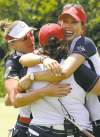 Chris Carlson / The Associated Press
United States captain Meg Mallon (centre) whoops it up with Michelle Wie (right) and teammate Brittany Lang after the pair won their foursome match Saturday.