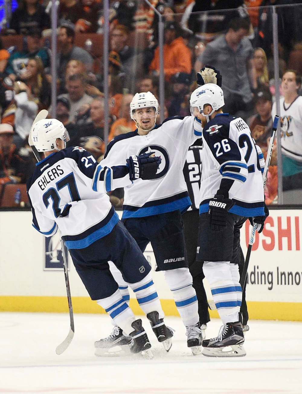 KELVIN KUO / ASSOCIATED PRESS FILES
Winnipeg Jets right wing Blake Wheeler, right, celebrates his overtime goal with center Mark Scheifele, centre, and right wing Nikolaj Ehlers in overtime against the Anaheim Ducks Tuesday.