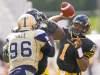 CP
Aaron Lynett / the canadian press
Hamilton Tiger-Cats quarterback Henry Burris passes over onrushing Winnipeg Blue Bomber Alex Hall.