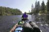 Ruth Bonneville / Winnipeg Free PressTracy Tjaden powers a canoe through sparkling water and outcrops of ancient rocks along the Manigotagan River in July.