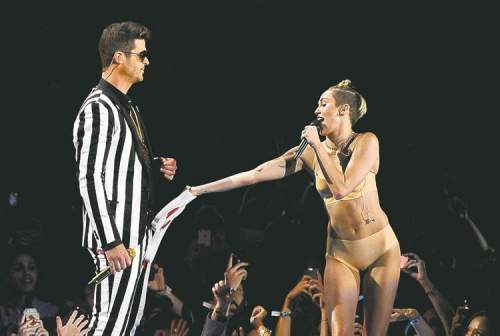 CP
Miley Cyrus upstages Lady Gaga as she performs Blurred Lines with Robin Thicke.