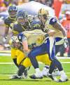 Mark Blinch / reuters archives
Bombers quarterback Buck Pierce (front) gets sacked by Tiger-Cats.