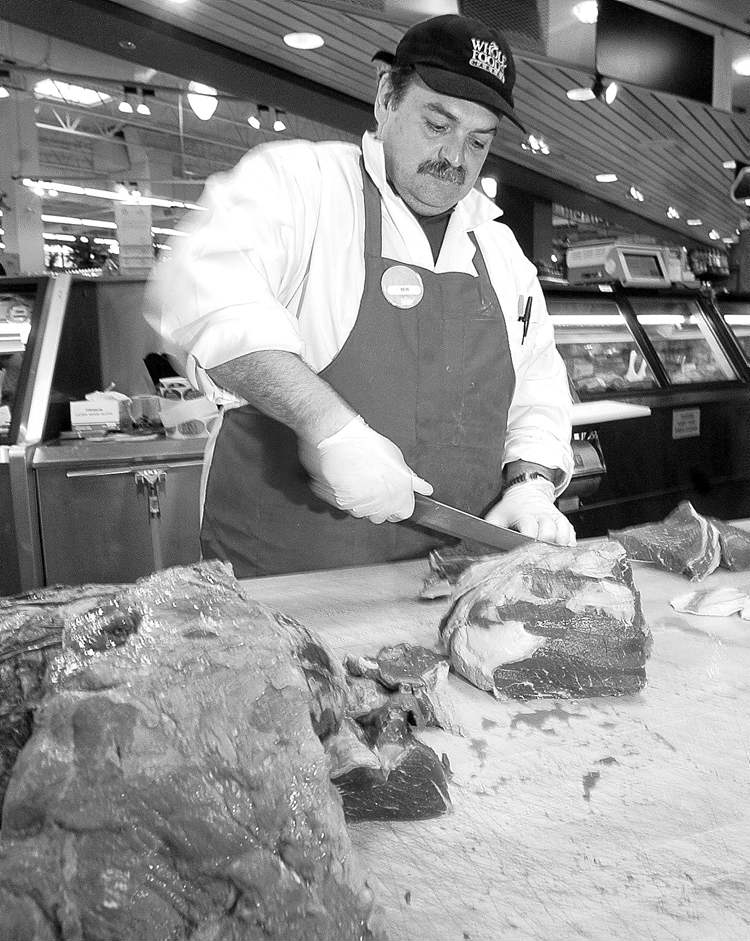 Postmedia
Butcher Bob Corbeil prepares beef at the Whole Foods Market in West Vancouver.