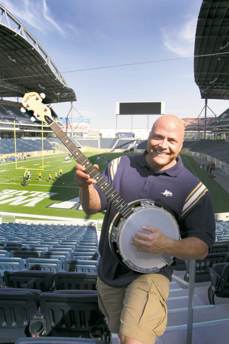 Troy Westwood poses with a banjo at Investors Group Field.