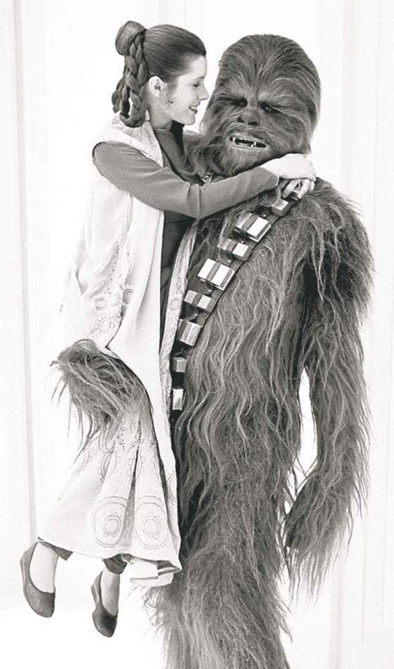 Tribune Media MCTActress Carrie Fisher jokes around with Chewbacca (Peter Mayhew) between takes on the set of the 1980 film �The Empire Strikes Back.
