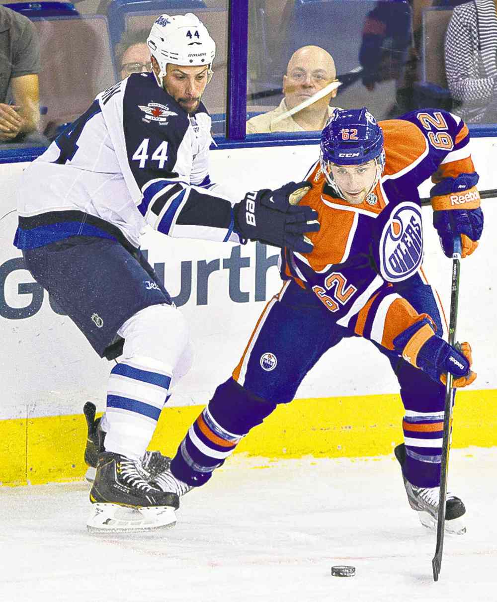 CP
Winnipeg Jet Zach Bogosian (left) and Edmonton Oilers� Mark Arcobello battle for the puck in the corner during the first period in Edmonton.