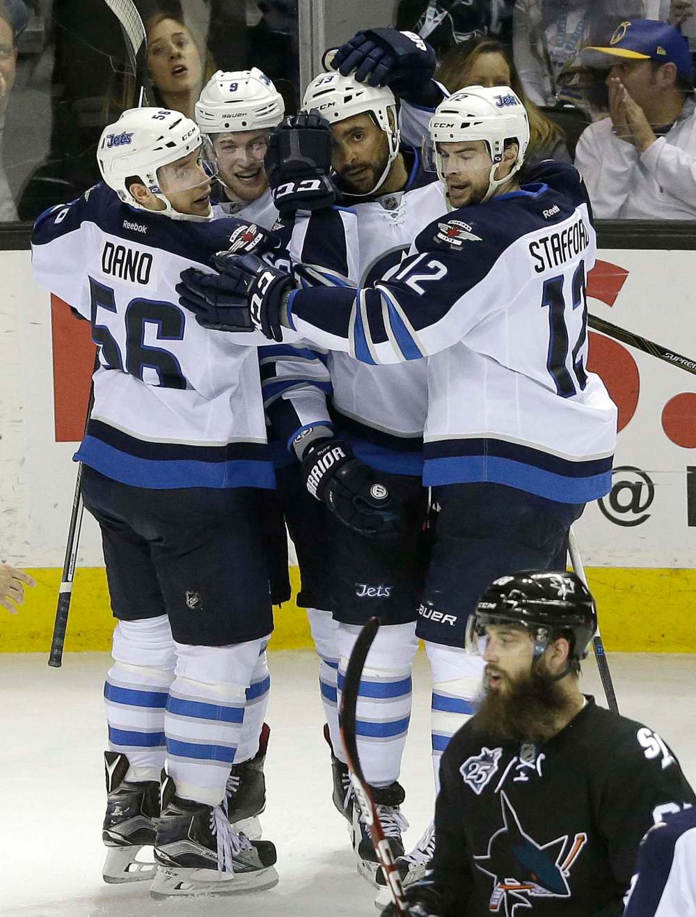 JEFF CHIU / THE ASSOCIATED PRESS
Dustin Byfuglien, second from right, celebrates with teammates after scoring against the San Jose Sharks during the third period.