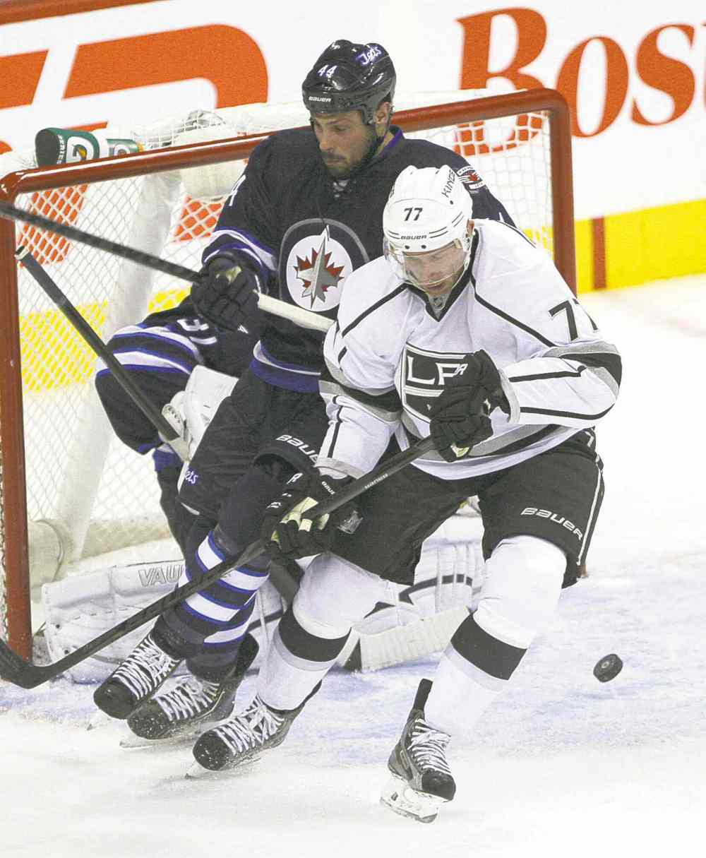 JOE BRYKSA / WINNIPEG FREE PRESS
The rejuvenated Jeff Carter battles with Jets defender Zach Bogosian Friday night at the MTS Centre.