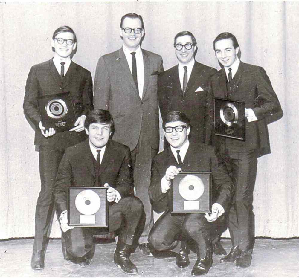 The Guess Who pose with Bob Burns and Doc Steen (back, second from right) in 1965. pose with