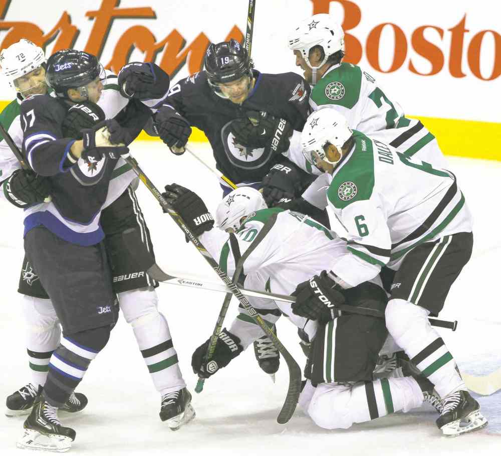 JOE BRYKSA / WINNIPEG FREE PRESS
Jets James Wright (left) and Jim Slater tangle with a bunch of Dallas Stars during the first period at the MTS Centre Friday. At left, Stars Brenden Dillon (4), Jamie Benn (14) and Tyler Seguin (91) celebrate Benn�s first-period goal.