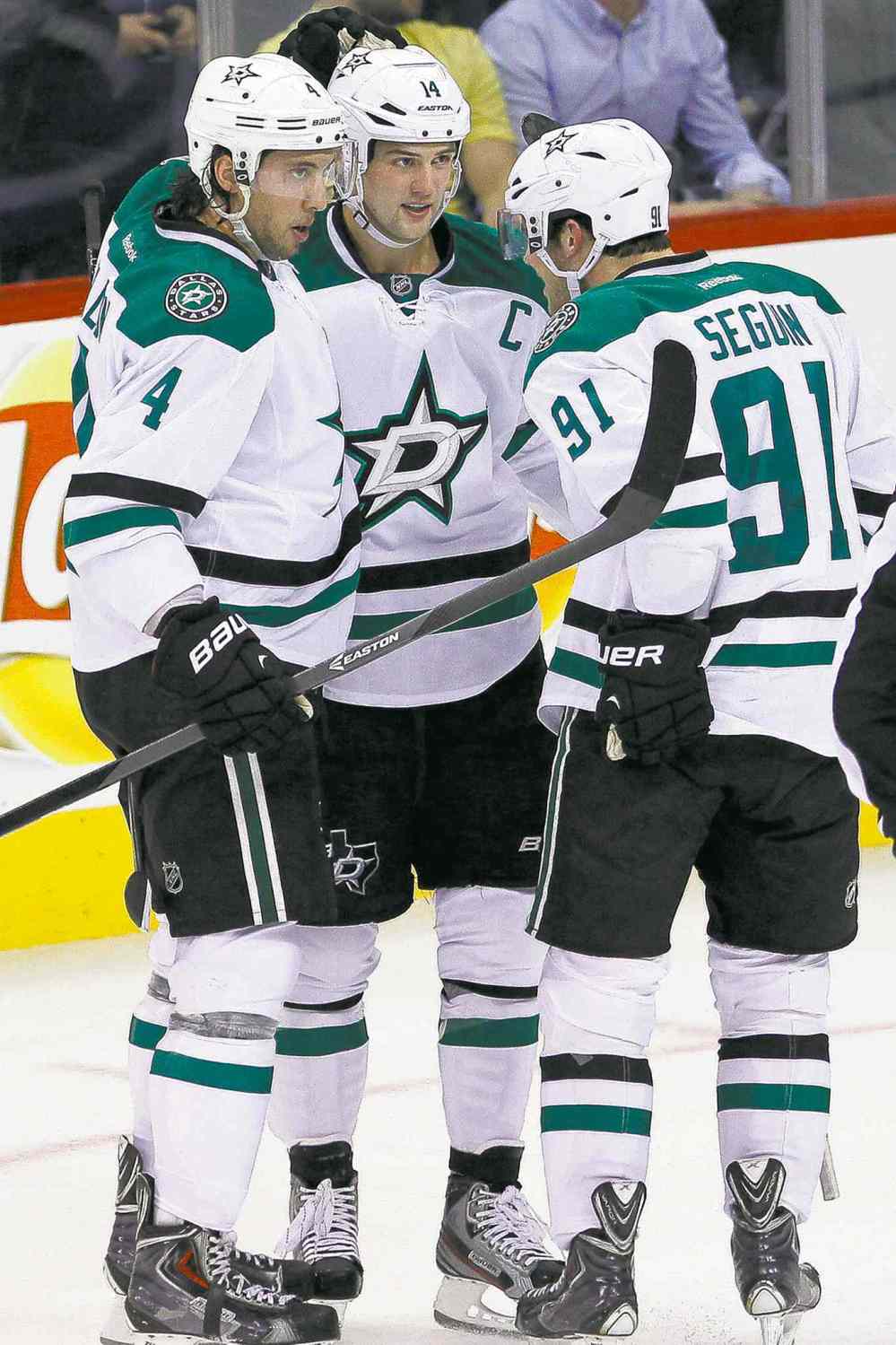 JOHN WOODS / THE CANADIAN PRESS
Stars Brenden Dillon (4), Jamie Benn (14) and Tyler Seguin (91) celebrate Benn's first-period goal.