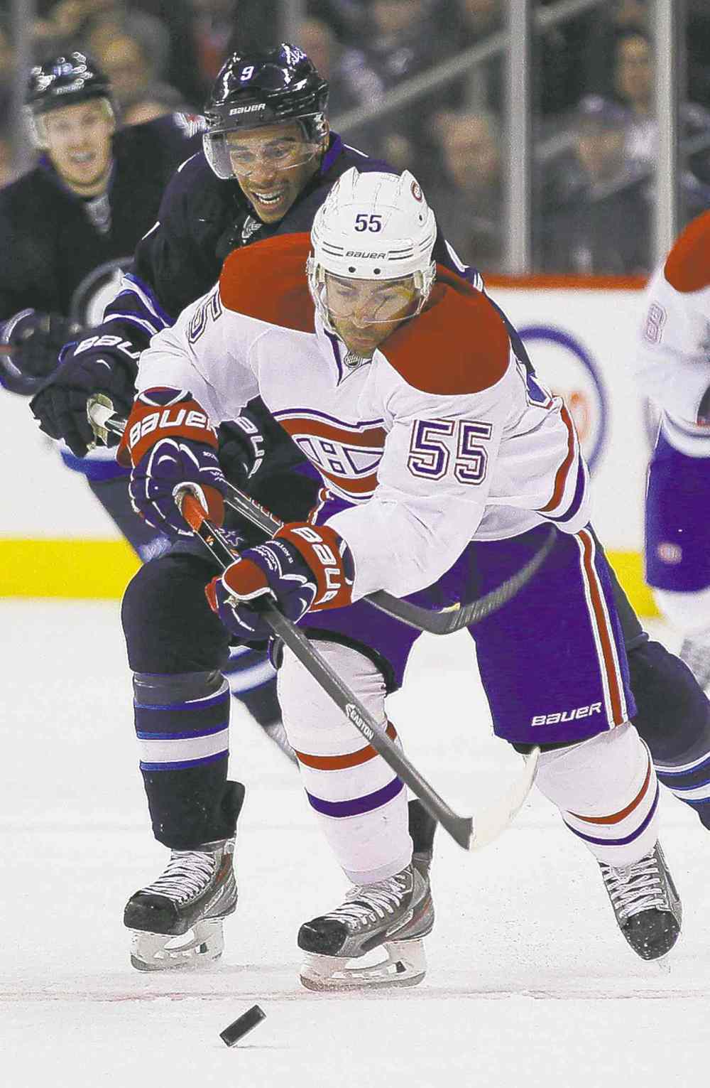 John Woods / WINNIPEG FREE PRESS
Winnipeg Jets' Evander Kane (rear) is tagged for hooking Montreal's Francis Bouillon. Kane picked up three minors on the night.
