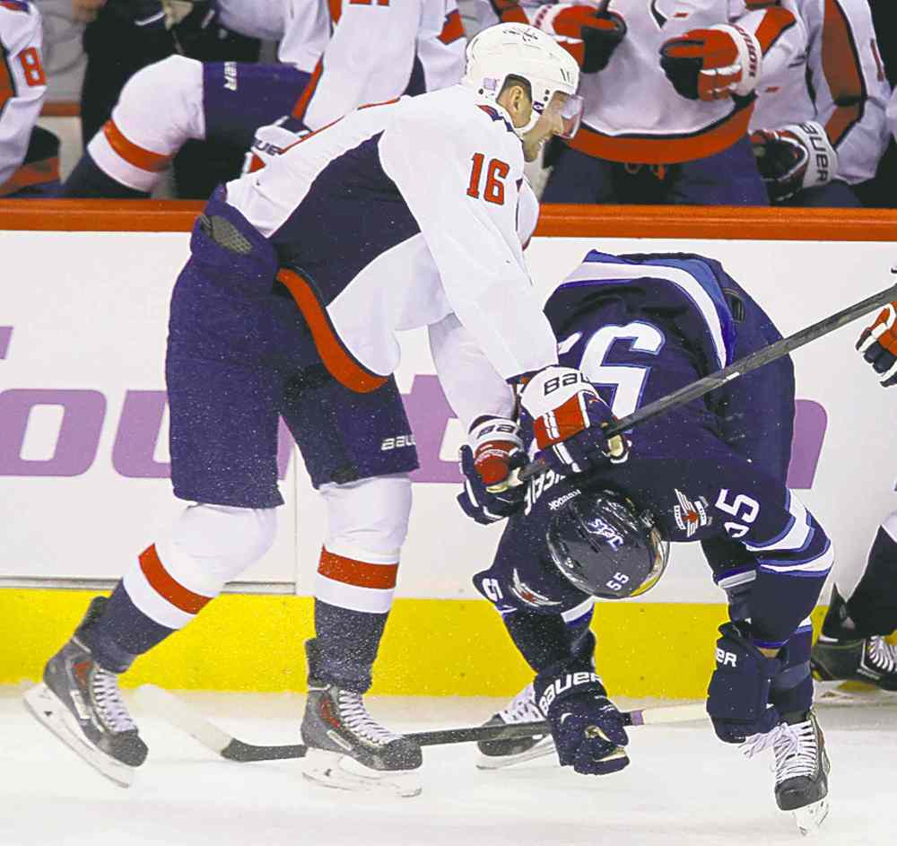 Trevor Hagan / the canadian press
The Capitals' Eric Fehr (16) two-hands Scheifele (55) in front of the Capitals bench during first-period action Tuesday.