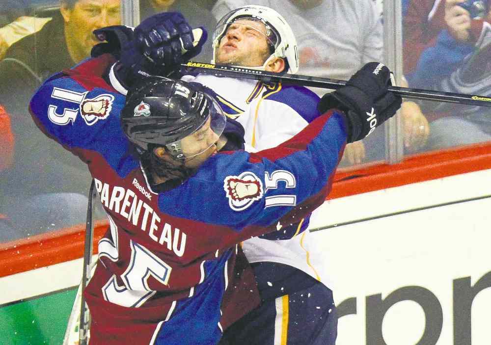 The Associated Press Archives
Fans react while watching Colorado Avalanche's P.A. Parenteau (15) high-stick St. Louis Blues' David Backes (42).