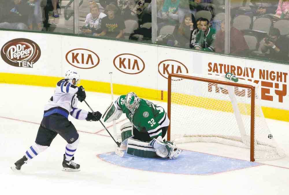 The Associated Press
Tony Gutierrez / the associated press
Winnipeg left-winger Andrew Ladd snaps the shootout winner past Stars goalie Kari Lehtonen Saturday night in Dallas.