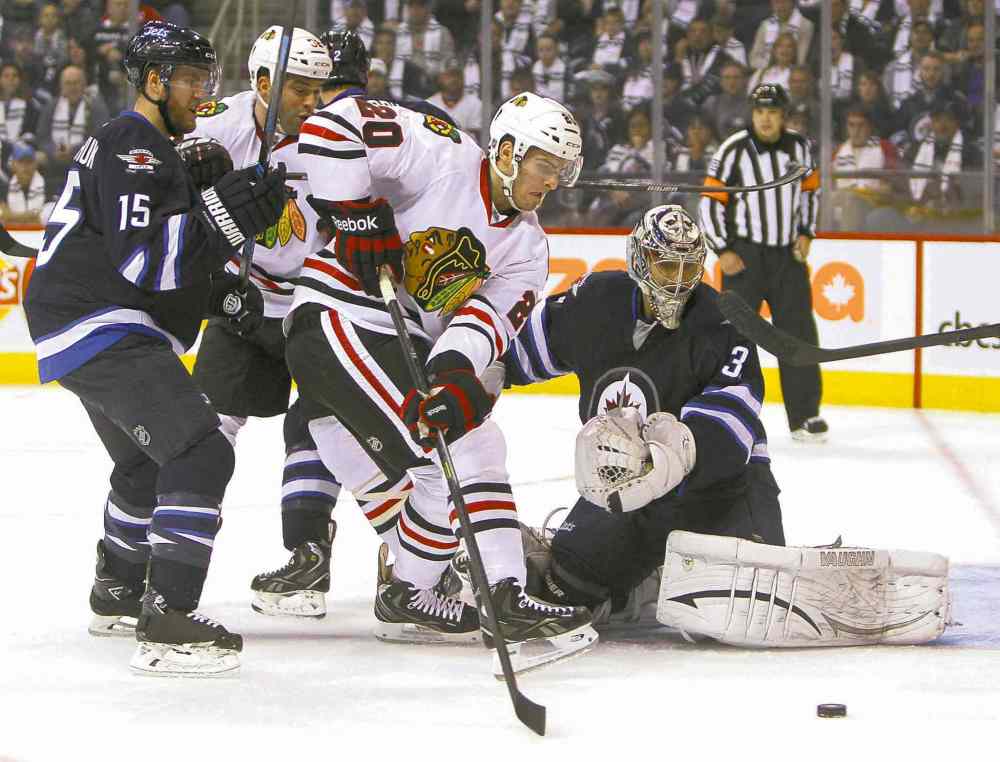 Ruth Bonneville / Winnipeg Free Press
Chicago�s Brandon Saad is stymied while trying to get the puck past Jets goalie Ondrej Pavelec during first-period action on Saturday.