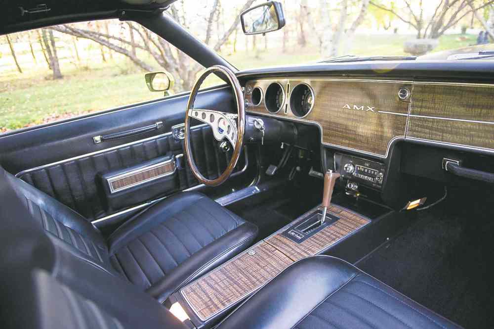 Original black vinyl bucket seats and center console with floor shift, Rim-Blow steering wheel.