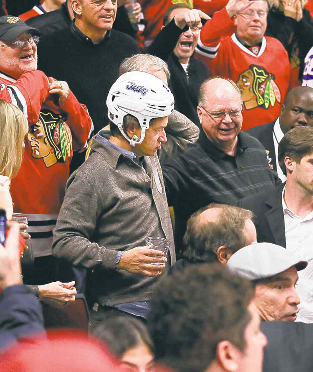 Nuccio DiNuzzo / Chicago Tribune archives
A fan dons Jets defenceman Adam Pardy's helmet during a game in Chicago Nov. 6.