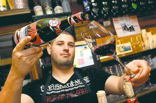 Bob Edme / The Associated Press
A server pours Beaujolais Nouveau in Bayonne, France on Thursday.
