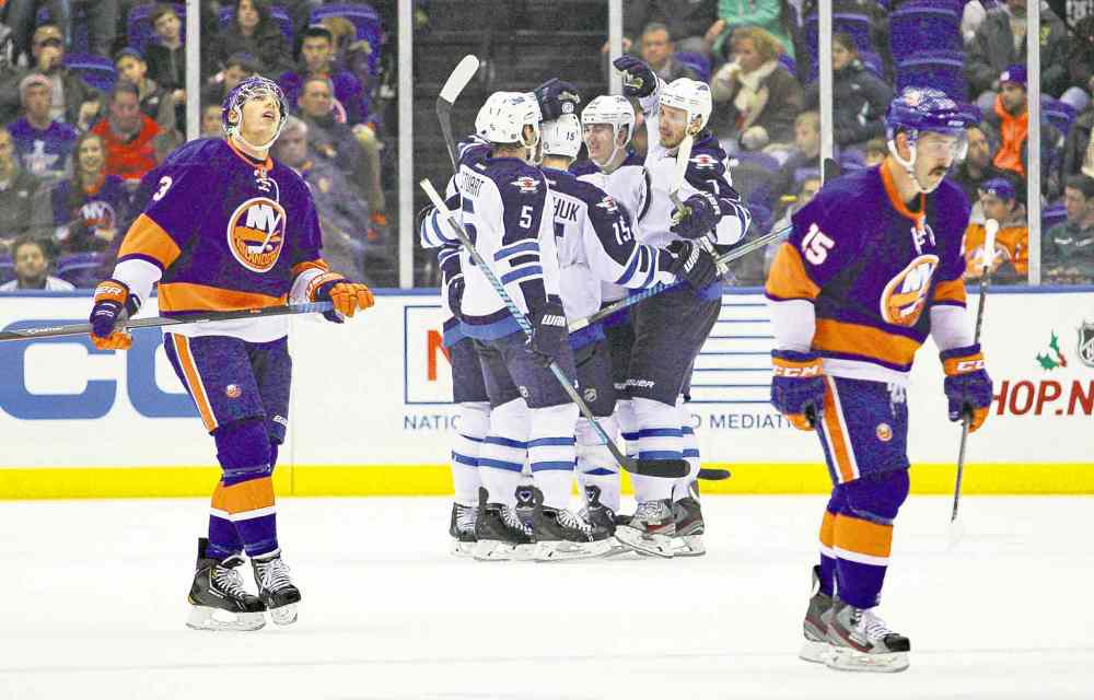 USA Today Sports
Brad Penner / USA TODAY Sports
Winnipeg�s Mark Stuart (5), Matt Halischuk (15), Mark Scheifele and Keaton Ellerby (7) celebrate Devin Setoguchi�s second-period goal Wednesday night.