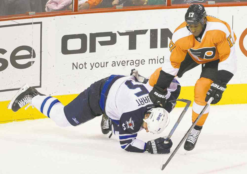 AP
Jets defenceman Mark Stuart goes down after getting tangled up with Flyers forward Wayne Simmonds in the third period Friday.