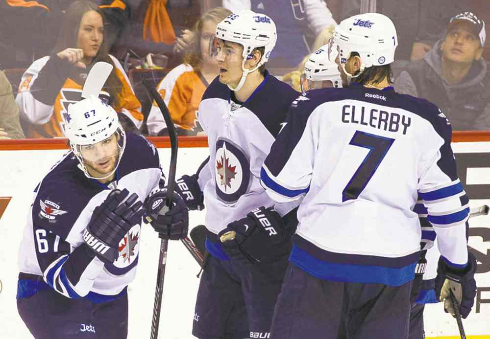 AP
Michael Frolik (left) celebrates his goal with Mark Scheifele and Keaton Ellerby.