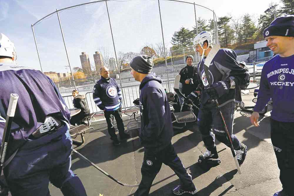CP
Mark Scheifele (second from right) approaches the Central Park rink for the outdoor practice session.