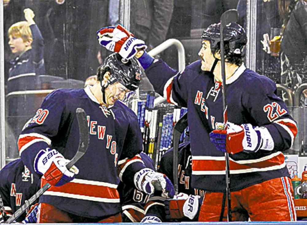 CP
New York Rangers' Brian Boyle, right, celebrates with Chris Kreider after Kreider scored during the third period of an NHL hockey game against the Vancouver Canucks Saturday, Nov. 30, 2013, at Madison Square Garden in New York. It was Kreider's third goal for a hat trick and the Rangers won 5-2. (AP Photo/Bill Kostroun)