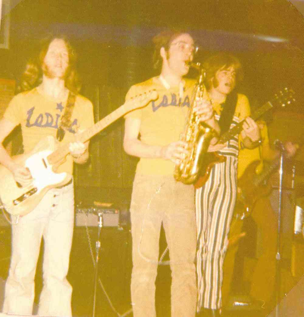 John Einarson (left) and Jim Fotheringham (right) play guitar at the Fireplace as Dave Pybus (centre) plays the saxophone in the summer of 1971.