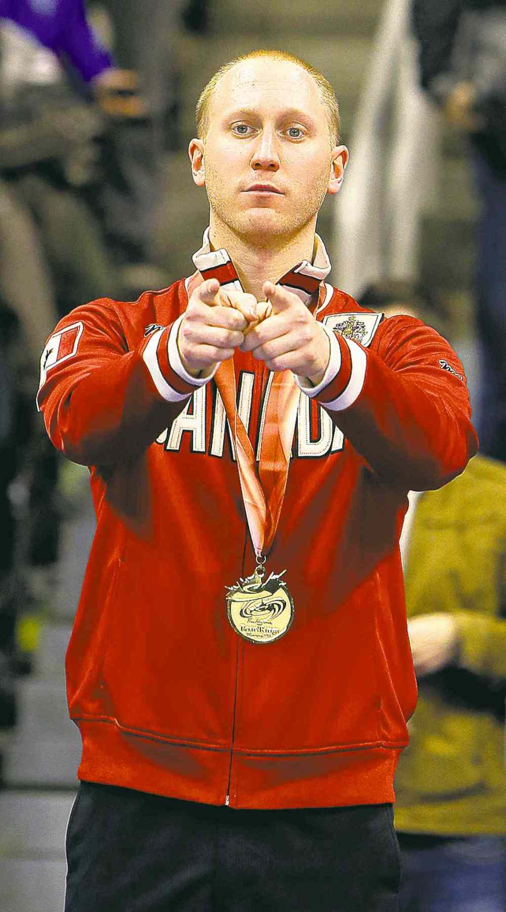 jason halstead / the winnipeg free press
Skip Brad Jacobs celebrates with the gold medal and the Team Canada jacket Sunday after defeating John Morris 7-4 to earn his Olympic berth.
