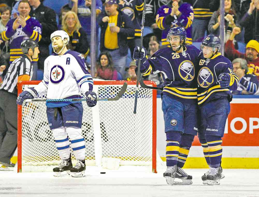 Kevin Hoffman / USA TODAY Sports
Sabres forward Matt Moulson (26) celebrates his power-play goal in the third period with teammate Tyler Ennis while Jets blue-liner Mark Stuart can't bear to look.