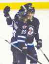 The Jets' Tobias Enstrom (39)  celebrates his goal with a Mark Scheifele during the first period Friday.