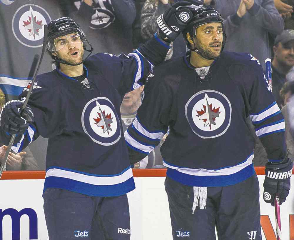 Jets Michael Frolik (67) and Dustin Byfuglien celebrates Frolik's second period goal.