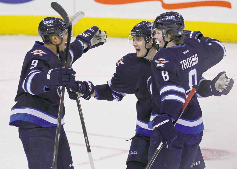 CP
John Woods / the canadian press files
Evander Kane (left), Mark Scheifele (centre) and Jacob Trouba celebrate Trouba�s goal against the Florida. Kane, Scheifele and Michael Frolik had fun scoring and blitzing the Florida zone Friday.