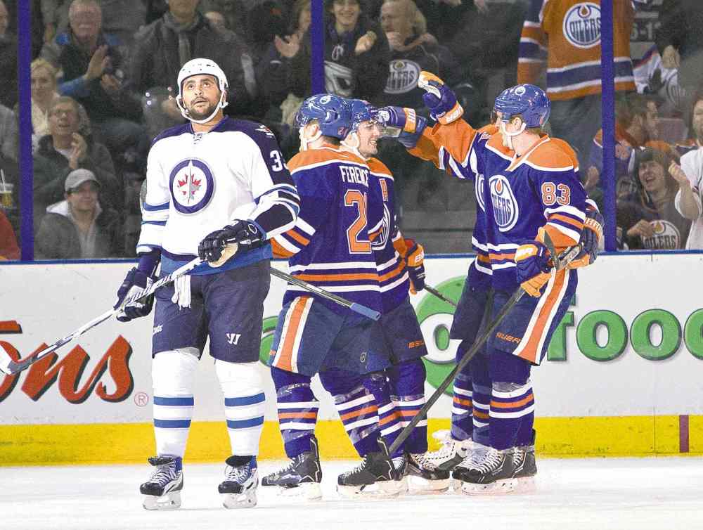 CP
Jason Franson / the canadian press files
The month of December has had Dustin Byfuglien singing the blues and glancing toward the heavens. It will be over soon, Big Buff.
