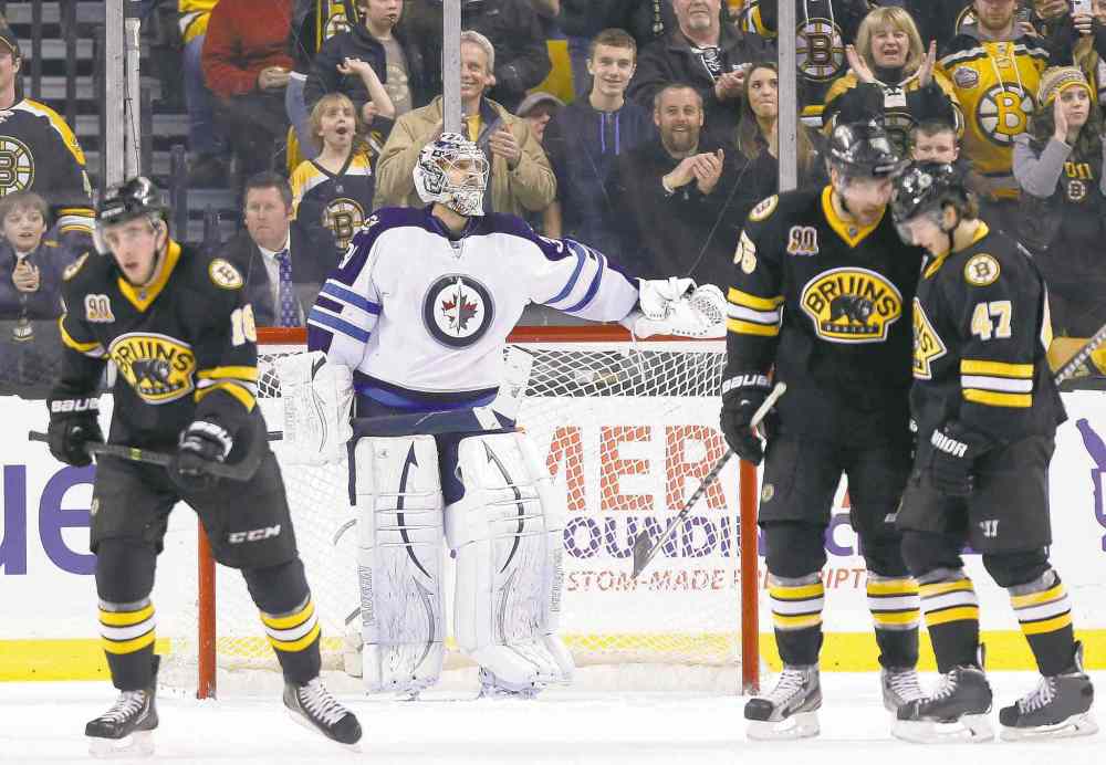 CP
Michael Dwyer / the associated press
Winnipeg Jets goalie Ondrej Pavelec stands disconsolate and alone as Boston Bruins Johnny Boychuk and Torey Krug (47) celebrate a third-period goal by teammate Reilly Smith (left).