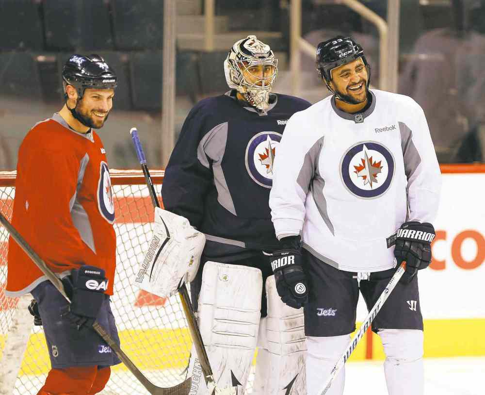 ken gigliotti / winnipeg free press
Dustin Byfuglien (right, with Zach Bogosian and Ondrej Pavelec) practised Thursday as a forward, fuelling speculation he might move up.