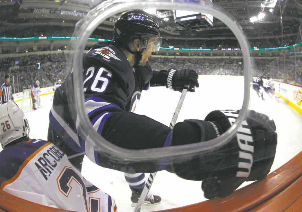TREVOR HAGAN / WINNIPEG FREE PRESS
Winnipeg�s Blake Wheeler (26) and Edmonton�s Mark Arcobello make poking a lens through the camera portal a risky business.
