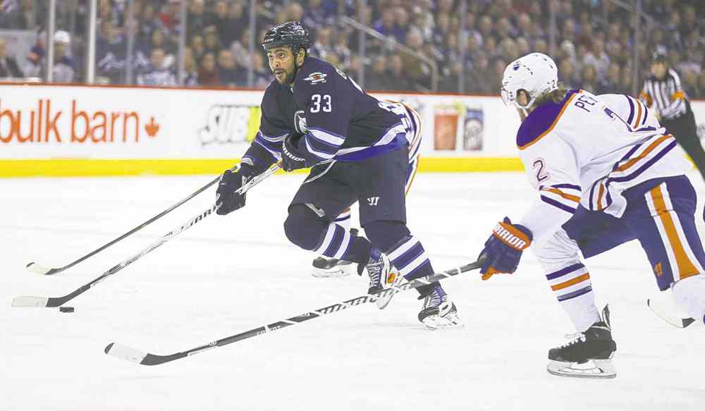 TREVOR HAGAN / WINNIPEG FREE PRESS
Jets right-winger Dustin Byfuglien drives to the net past Oilers defenceman Jeff Petry.