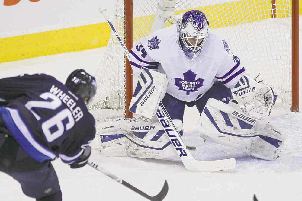 CP
John Woods / THE CANADIAN PRESS
Winnipeg�s Blake Wheeler beats Toronto goaltender James Reimer through the five-hole during first-period action Saturday.