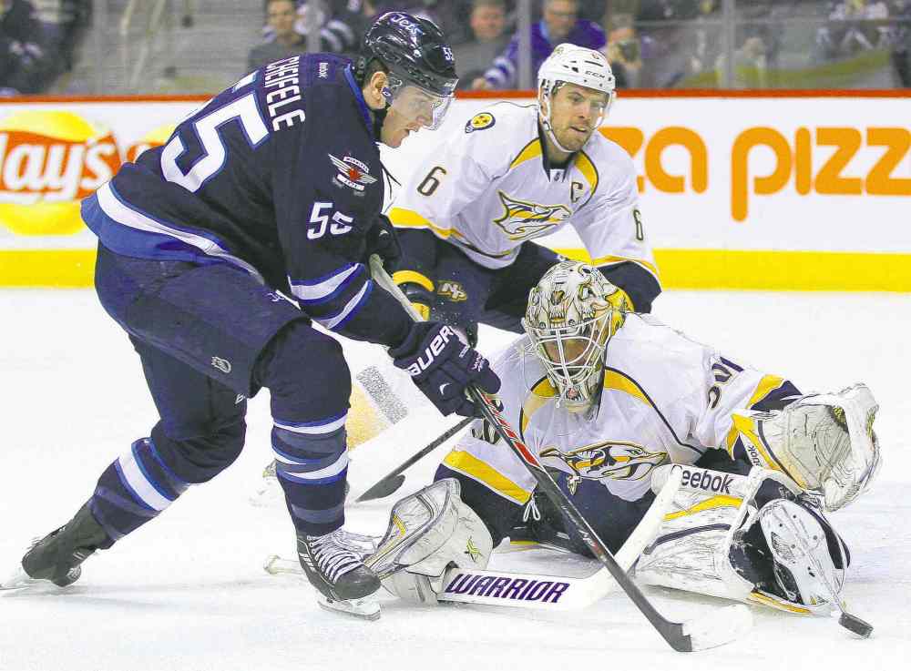 John Woods / WINNIPEG FREE PRESS
Jets' Mark Scheifele gets around Predators goaltender Carter Hutton before shooting the puck off Shea Weber for a goal.