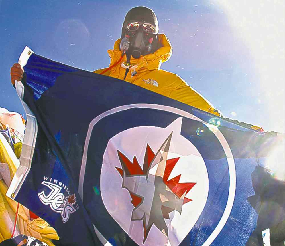 Handout
Dean Carriere on top of Mount Everest holding a Winnipeg Jets flag.