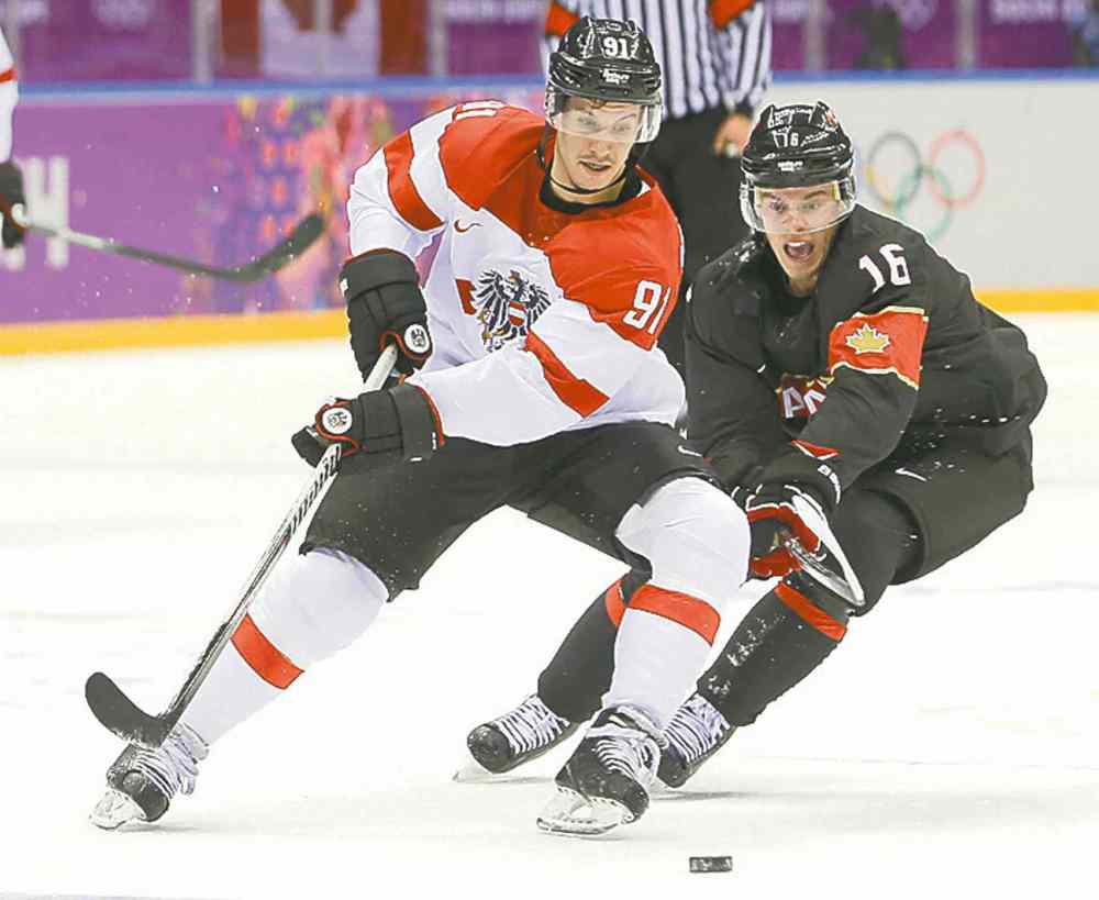 Mark Humphrey / The Associated Press
Austria's Oliver Setzinger (left) and Canada's Jonathan Toews chase the rubber Friday.