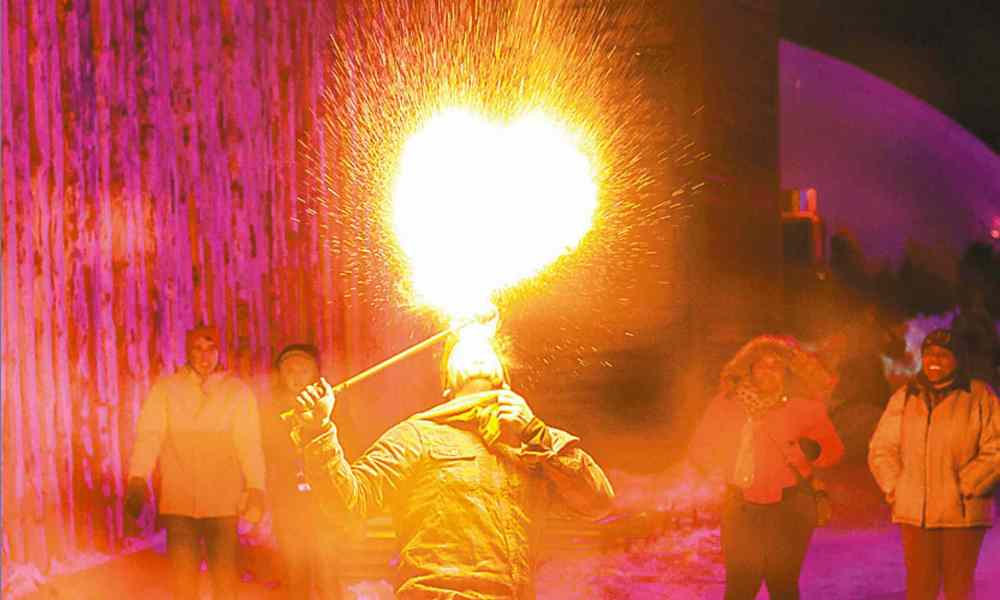 GREG GALLINGER / WINNIPEG FREE PRESS
Isaac Girardin breathes fire as Festival goers look on.