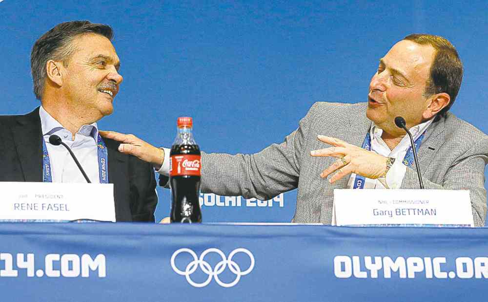 mark humphrey / the associated press
NHL commissioner Gary Bettman (right) and IIHF president Rene Fasel spar at a news conference in Sochi Tuesday. Olympic gold is 'almost as good' as a Stanley Cup win, Bettman jabbed.
